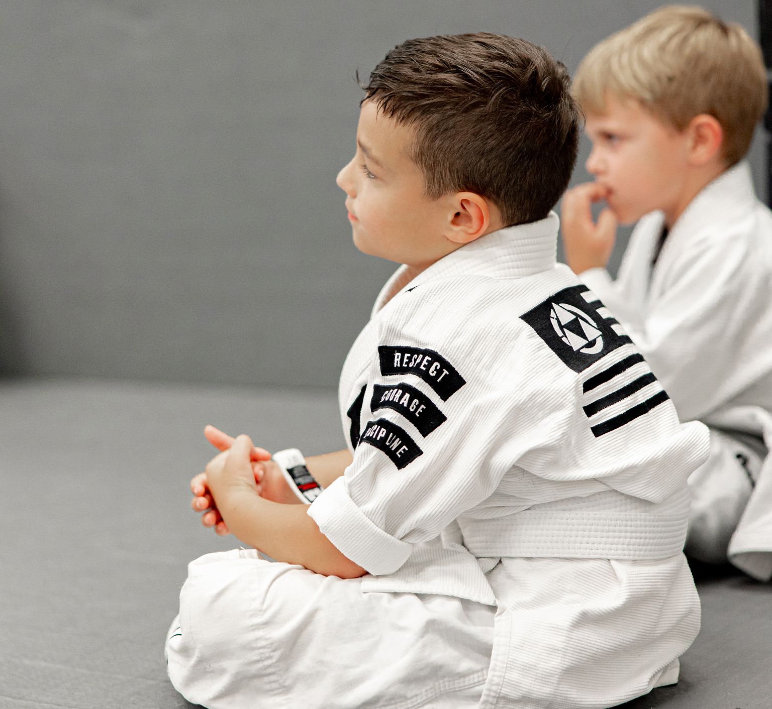 Coaches working with young students at Miller Martial Arts