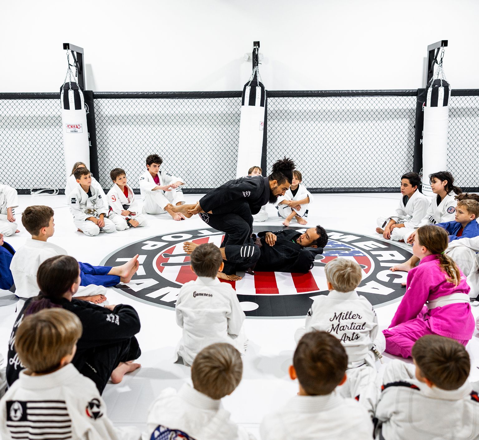 Coaches working with young students at Miller Martial Arts