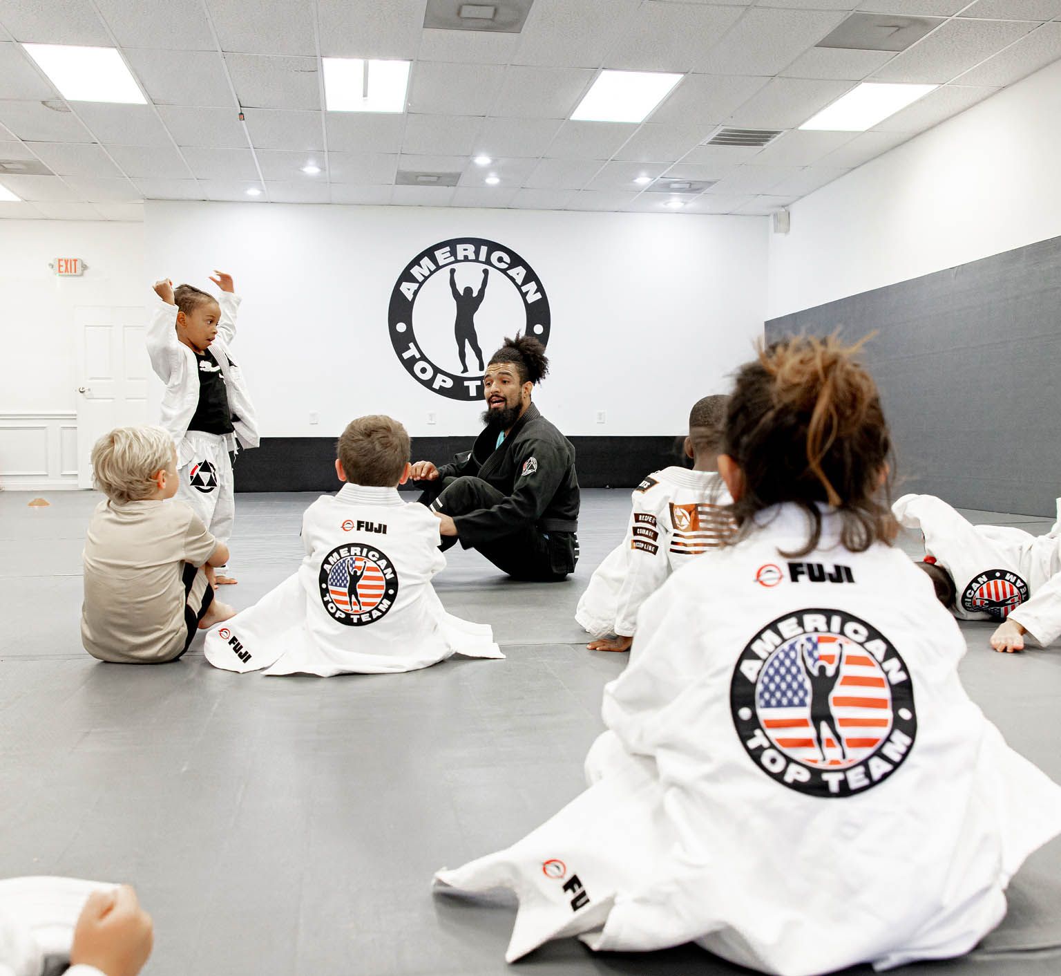 Coaches working with young students at Miller Martial Arts